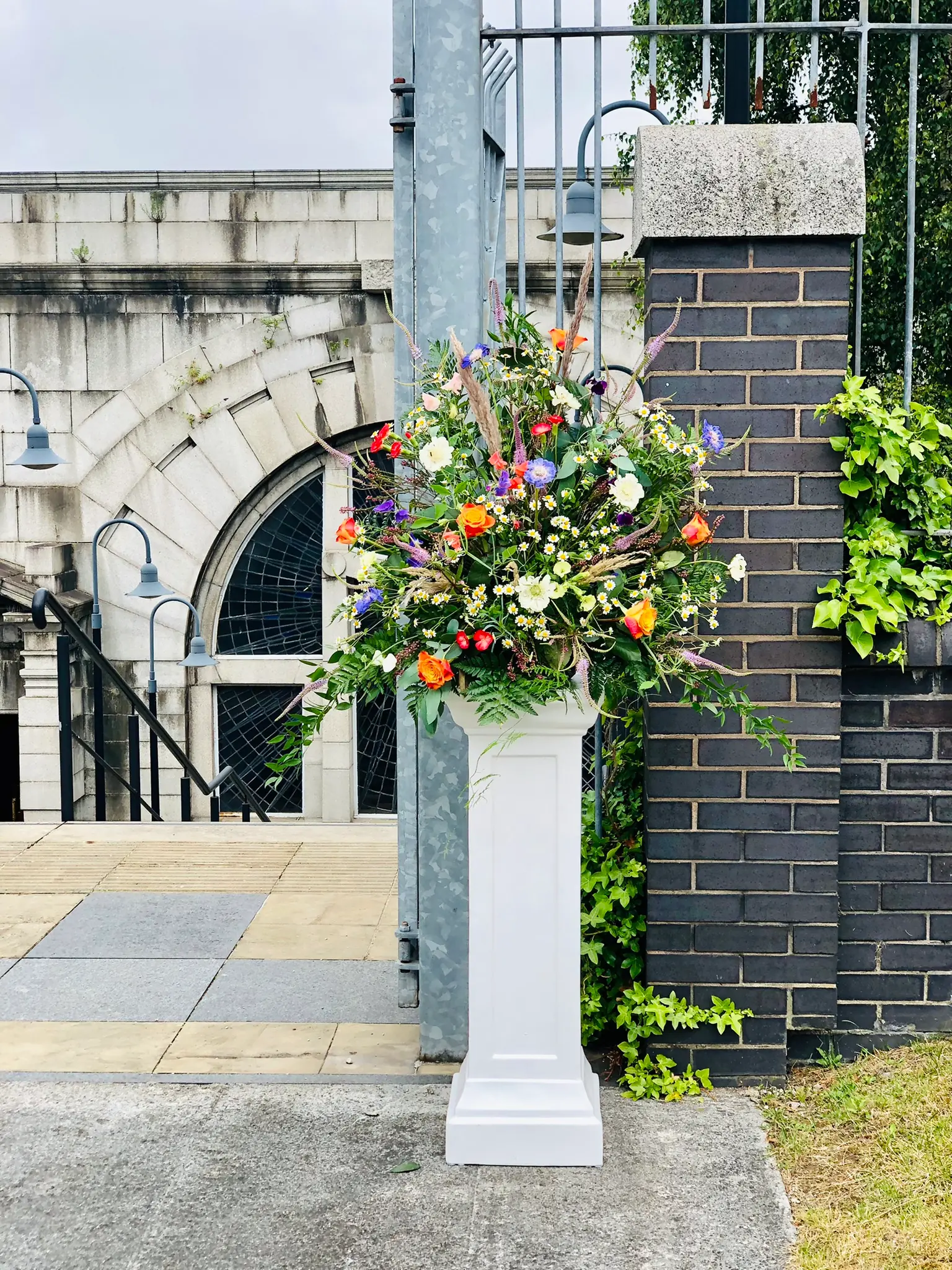 Wedding ceremony Entrance pedestal flower arrangement on plinth